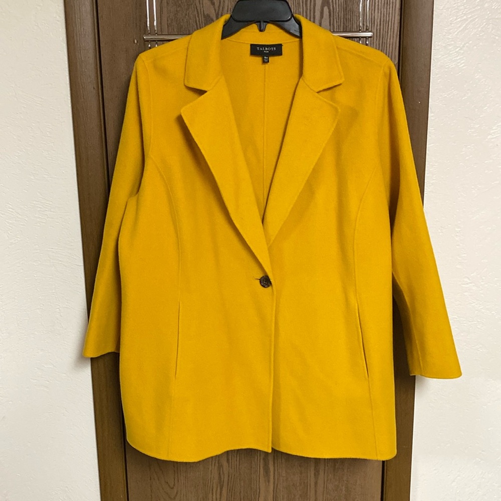 A woman’s mustard, yellow wool coat.